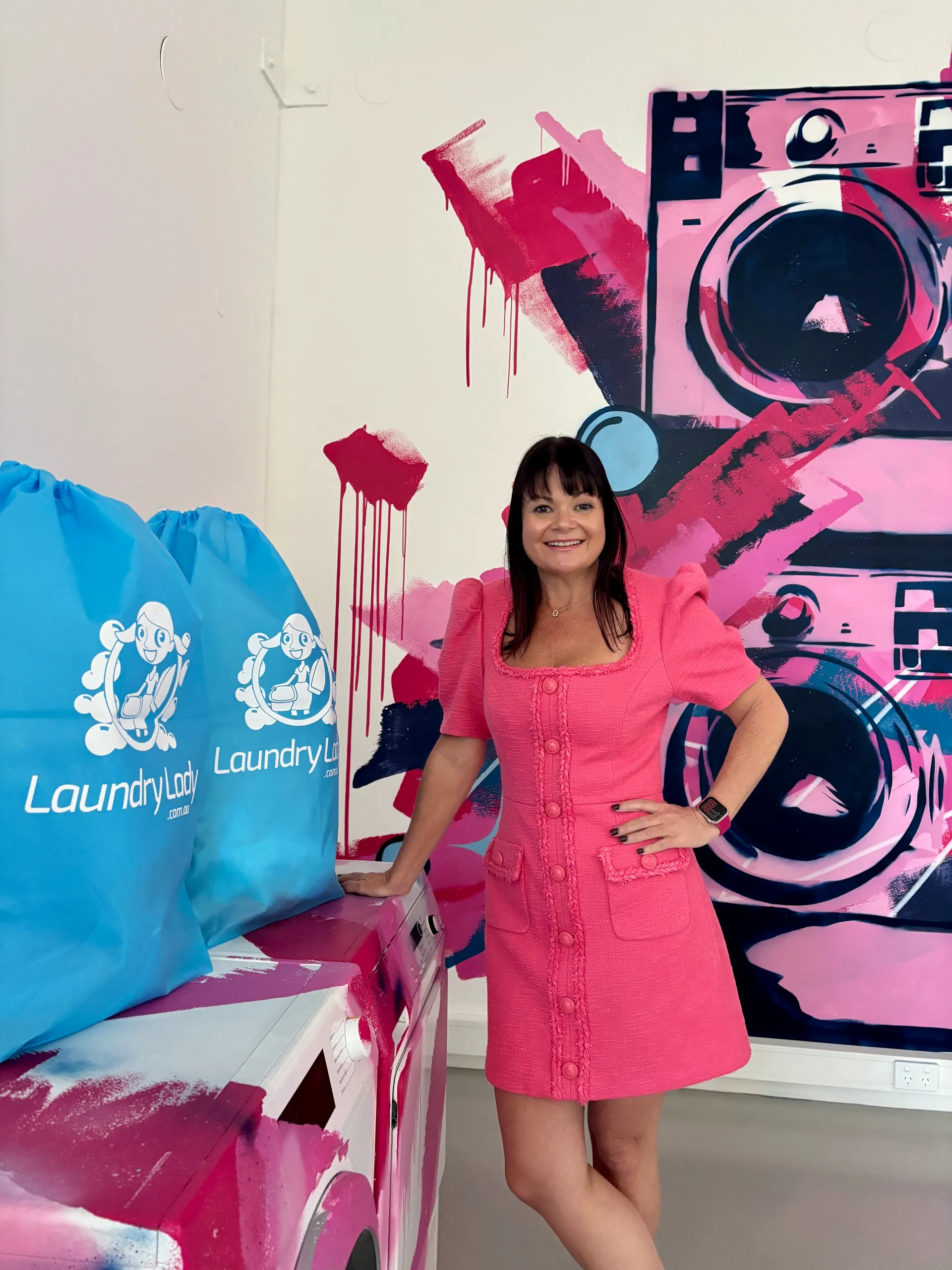 Laundry%20Lady%20CEO%20Susan%20Toft_bags%20and%20graffiti%20wall_1.jpg
