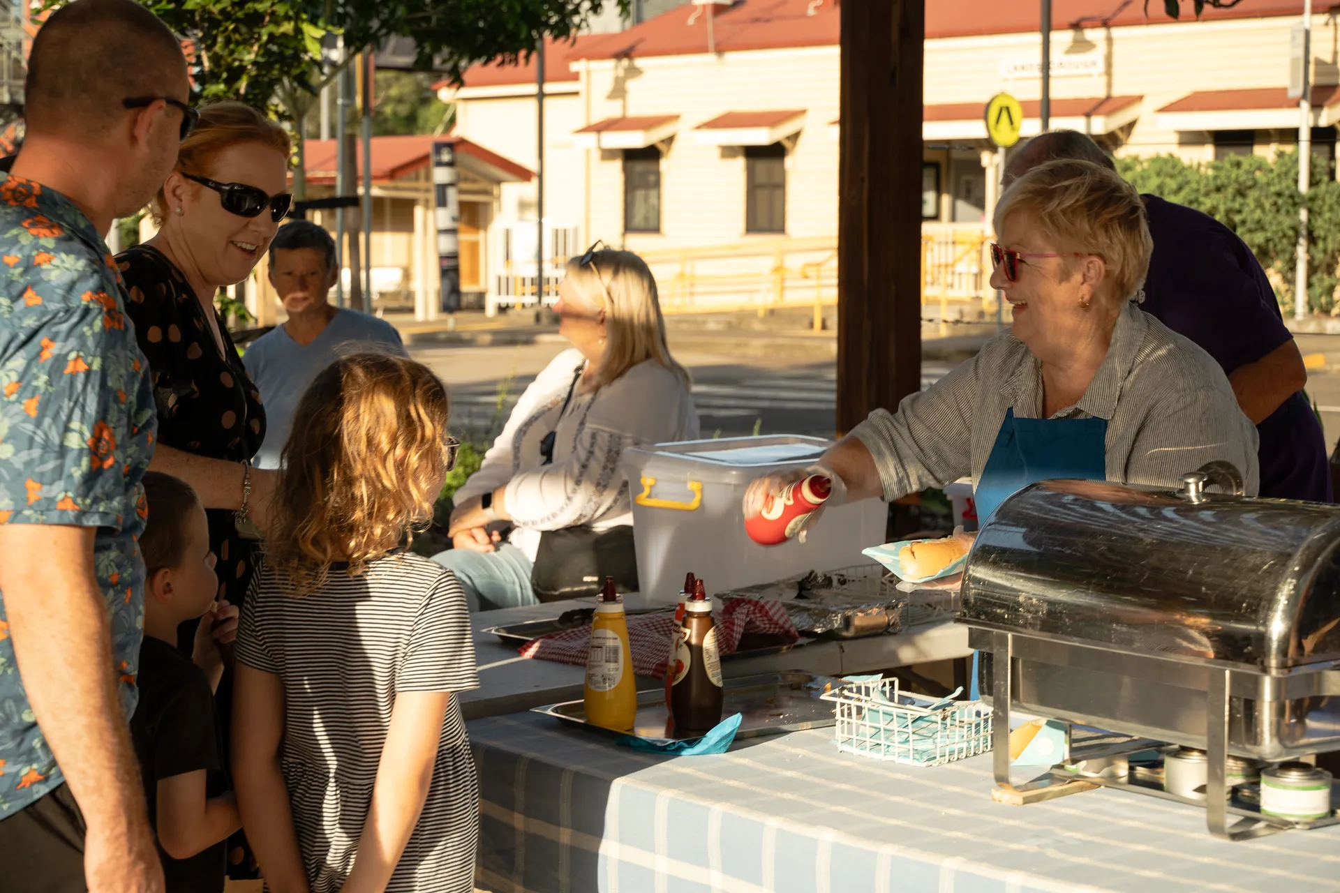 The community enjoying a sausage sizzle at the Community Event to celebrate the completion of the Cribb Street Streetscape, Landsborough.