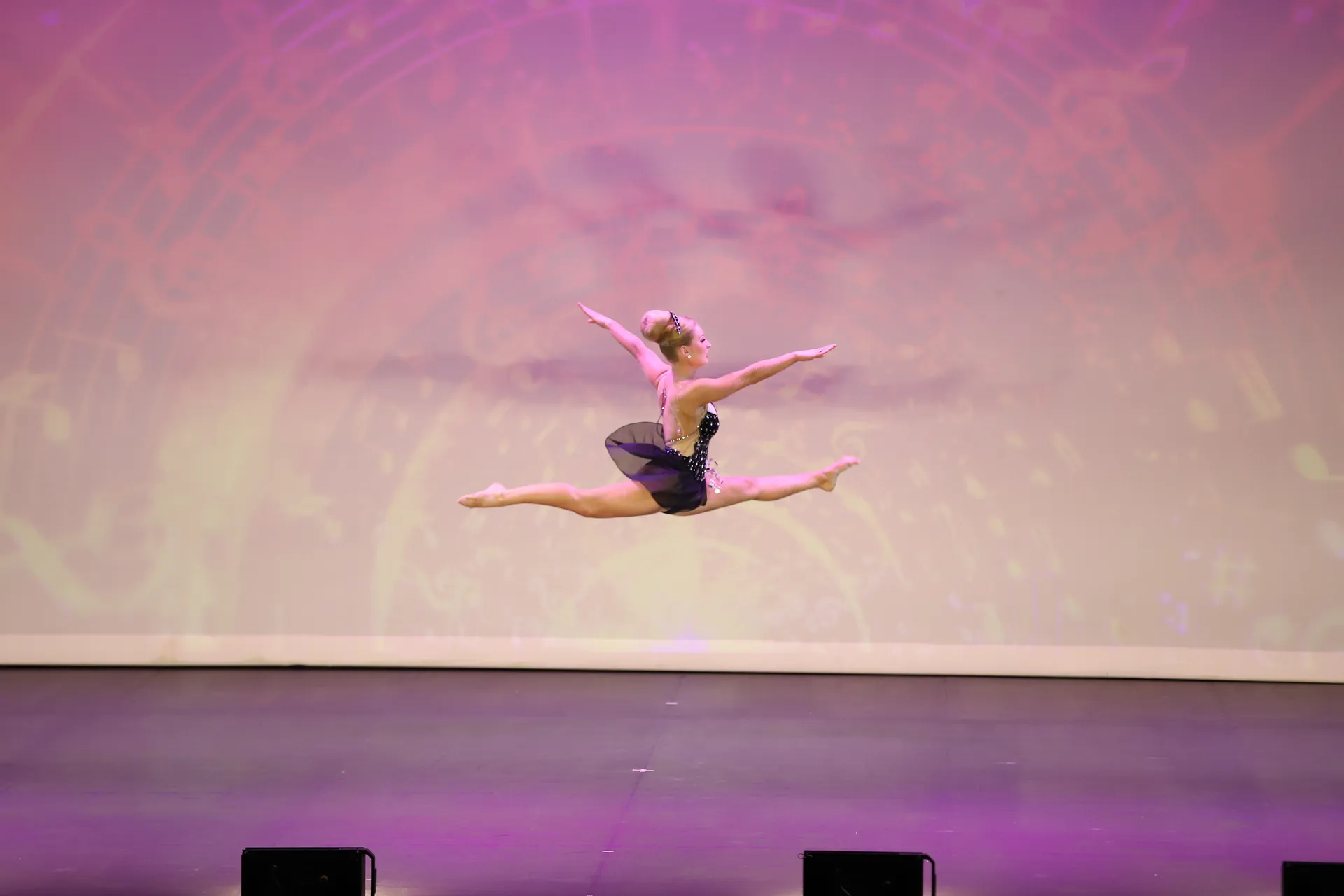 A gymnastic in flight during her routine.