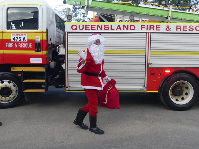 Santa waving while delivering gifts