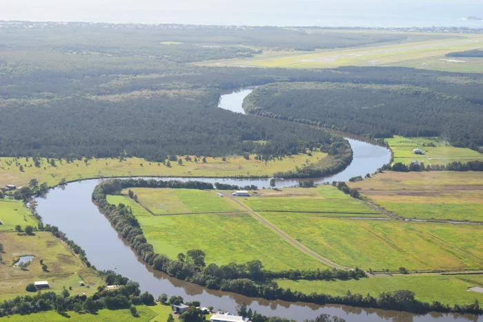 The Maroochy River winds through the Blue Heart, with part of the River Road trial site in view (middle left).