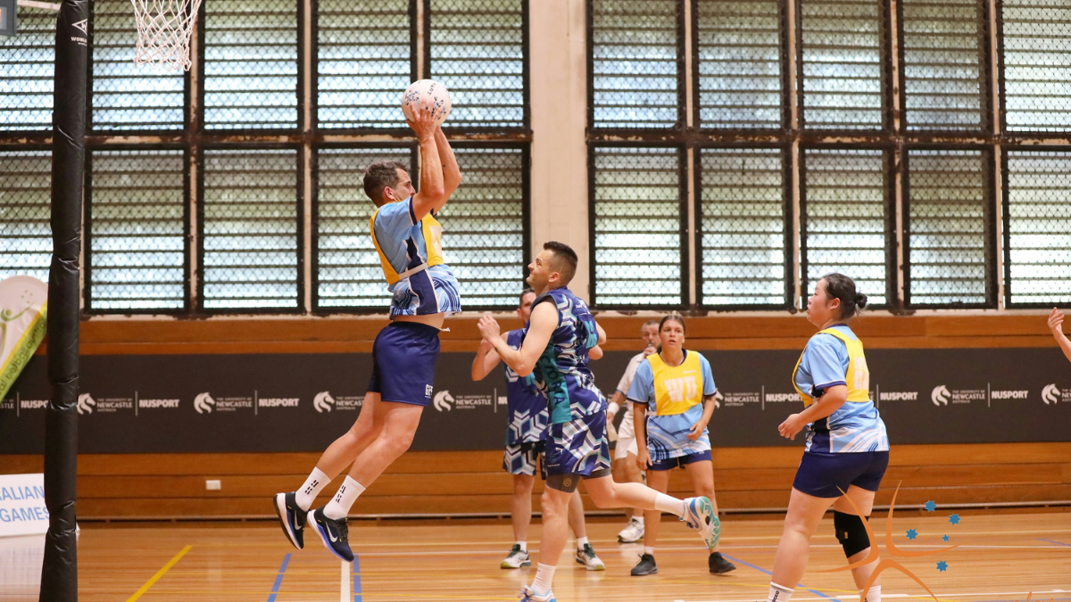 Basketball players - with one jumping high in the air to catch or throw the ball.