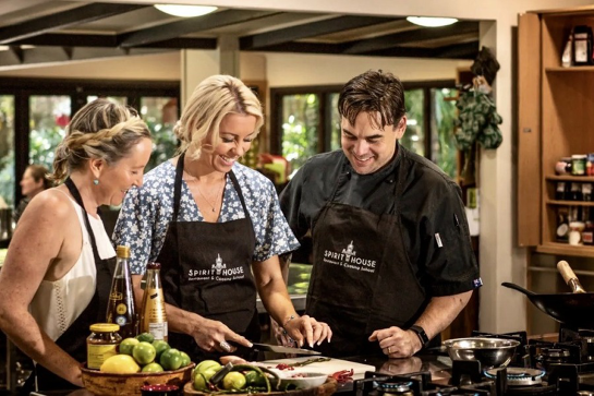 Three people participating in a cooking class