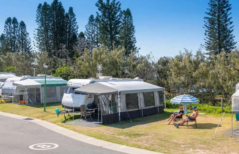 Coolum Beach holiday park couple sitting near caravan