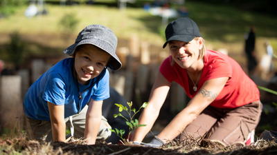 Mother and son planting a native Australian tree in Buderim