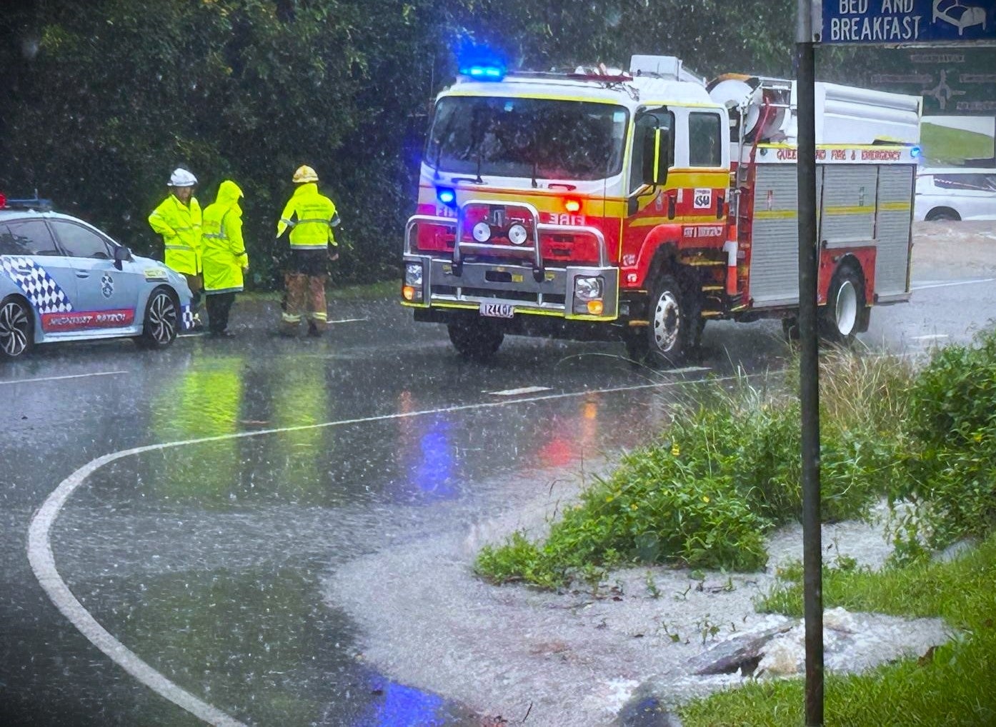 flooded car and emergency vehicles