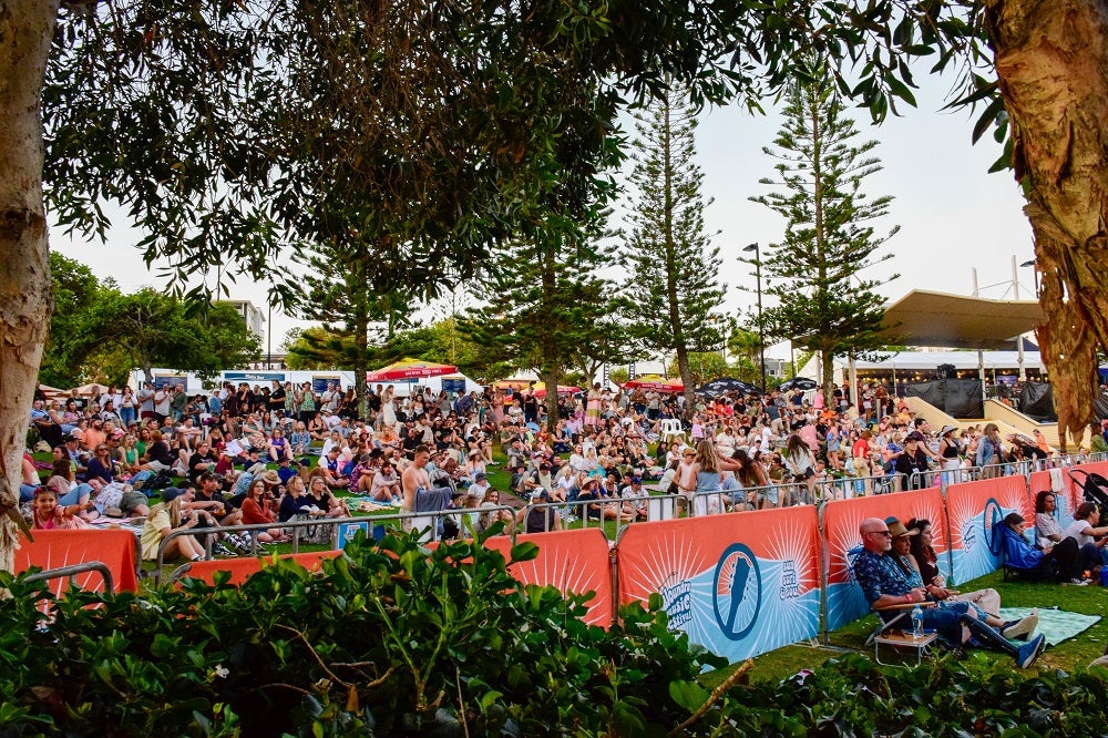 View of the crowd in the main bar area on the grassy hill at Caloundra Music Festival 2023