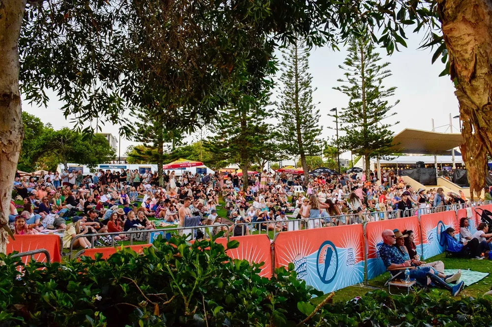 View of the crowd in the main bar area on the grassy hill at Caloundra Music Festival 2023