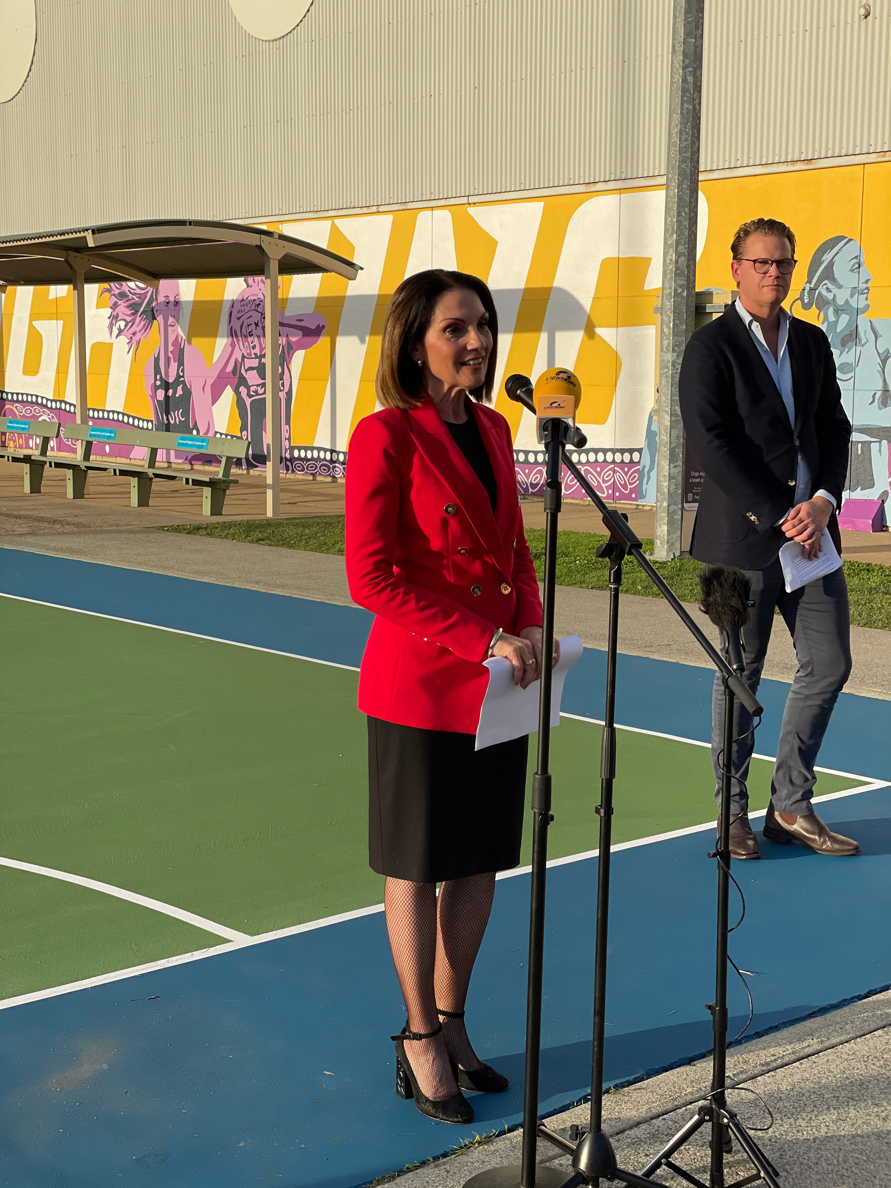 Mayor Rosanna Natoli speaking to a netball fans about the new mural.