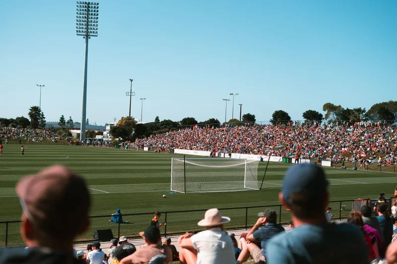Taken from the crowd, looking towards a game of football in play with Brisbane Roar.