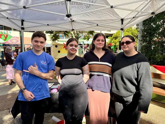Group of young people engaging with Youth Plan team at a NAIDOC event