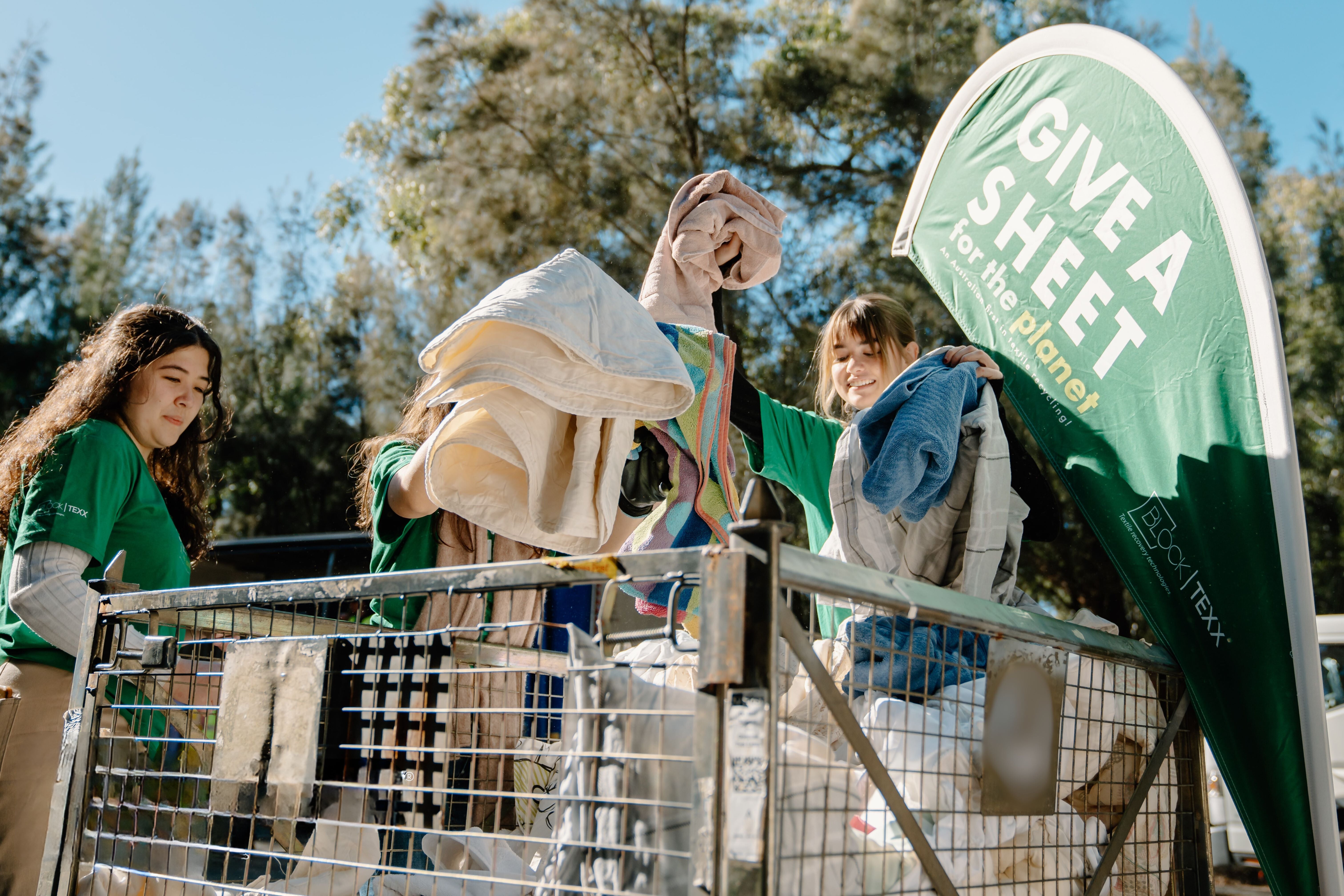 Volunteers sorting through donations at Give a Sheet event