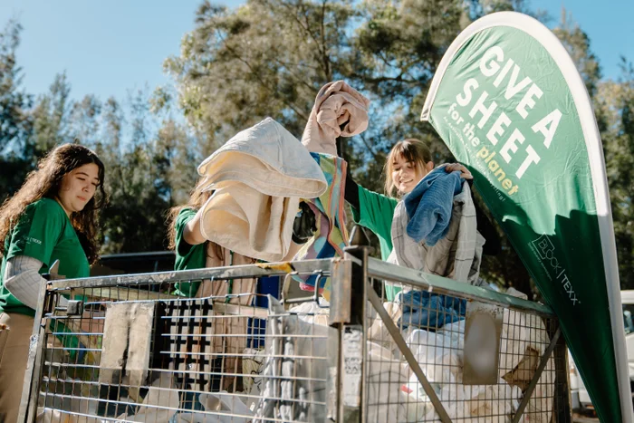 Volunteers sorting through donations at Give a Sheet event