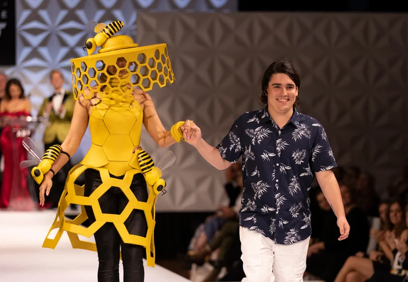AWAF 2023 Headpiece Winner, Artist Teddy McRitchie and Model Georgia-Phillips walking the runway.