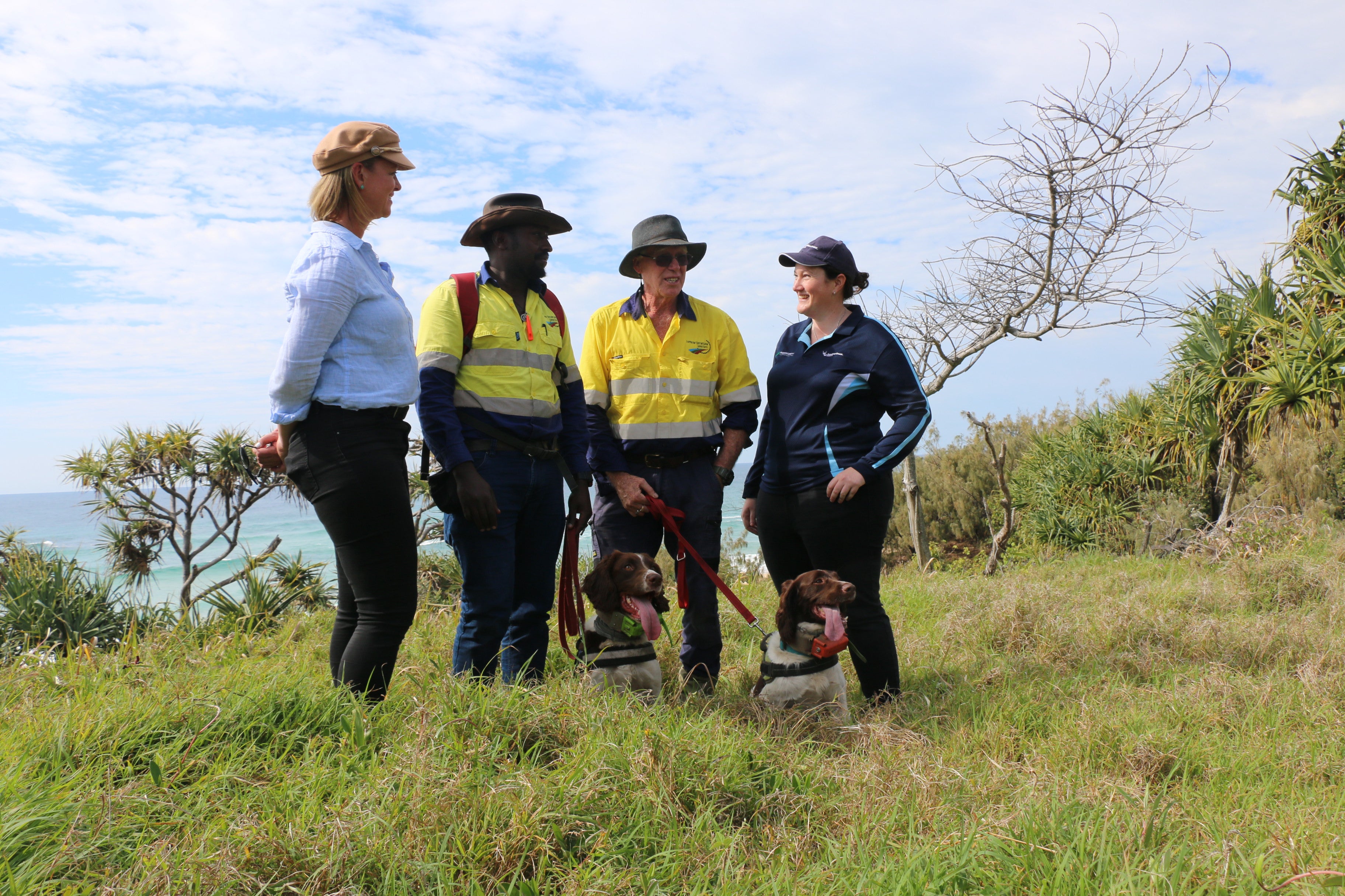 (From left) Councillor Maria Suarez, handler Agaba Hannington, handler Tom Garrett, and Biosecurity Technical Officer Rita Everitt with Hakka and Cooper. 