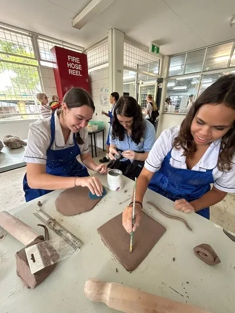 First Nations students from Caloundra State High School working with clay to create songlines sculptures