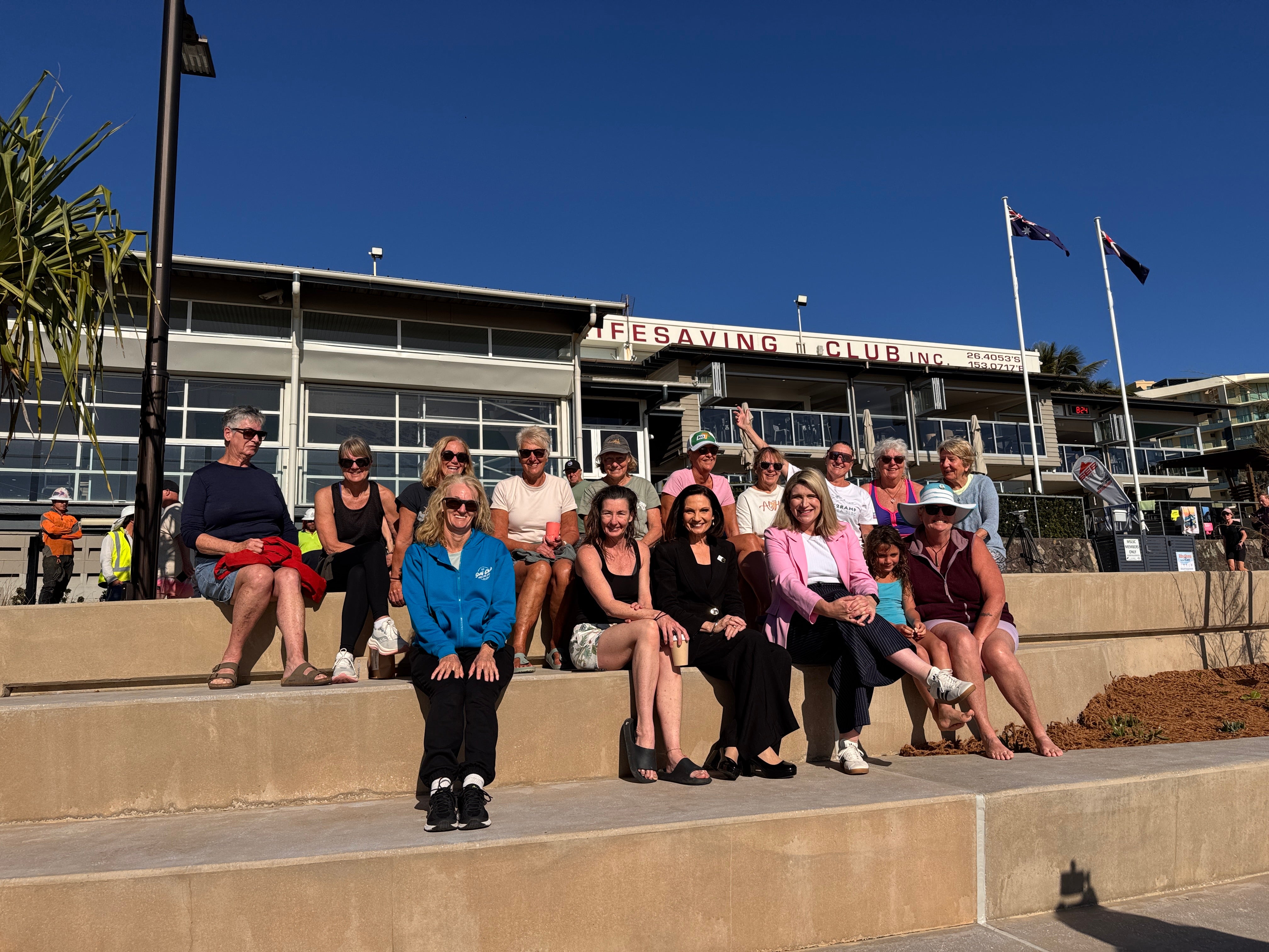 Community members seated along the new terraced seawall. 