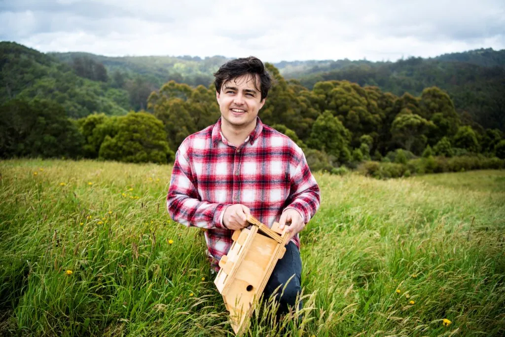 Project Ninox Director Jack Spittle and the PIR device attached to the hardwood nestbox.