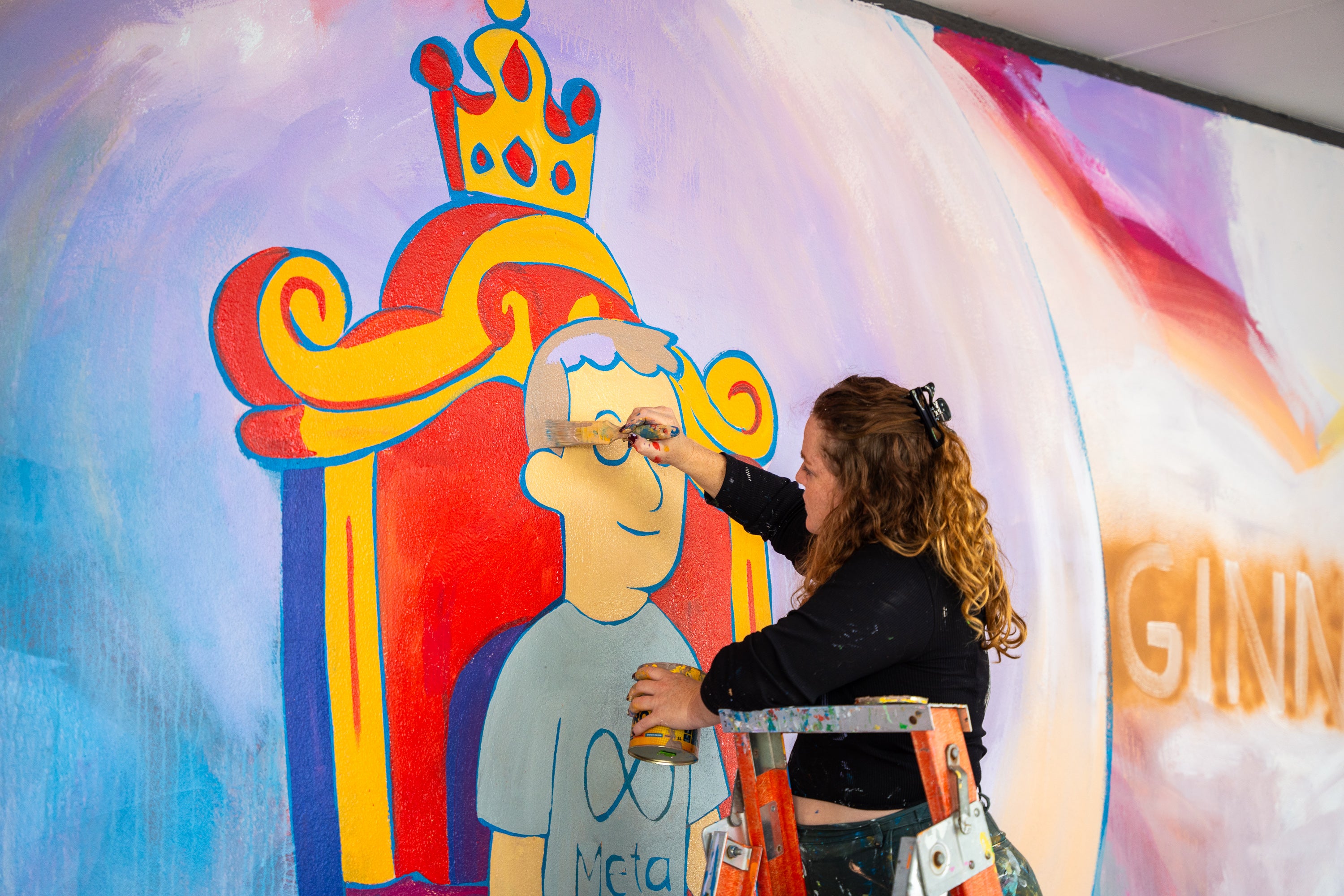 Alison Mooney painting a mural