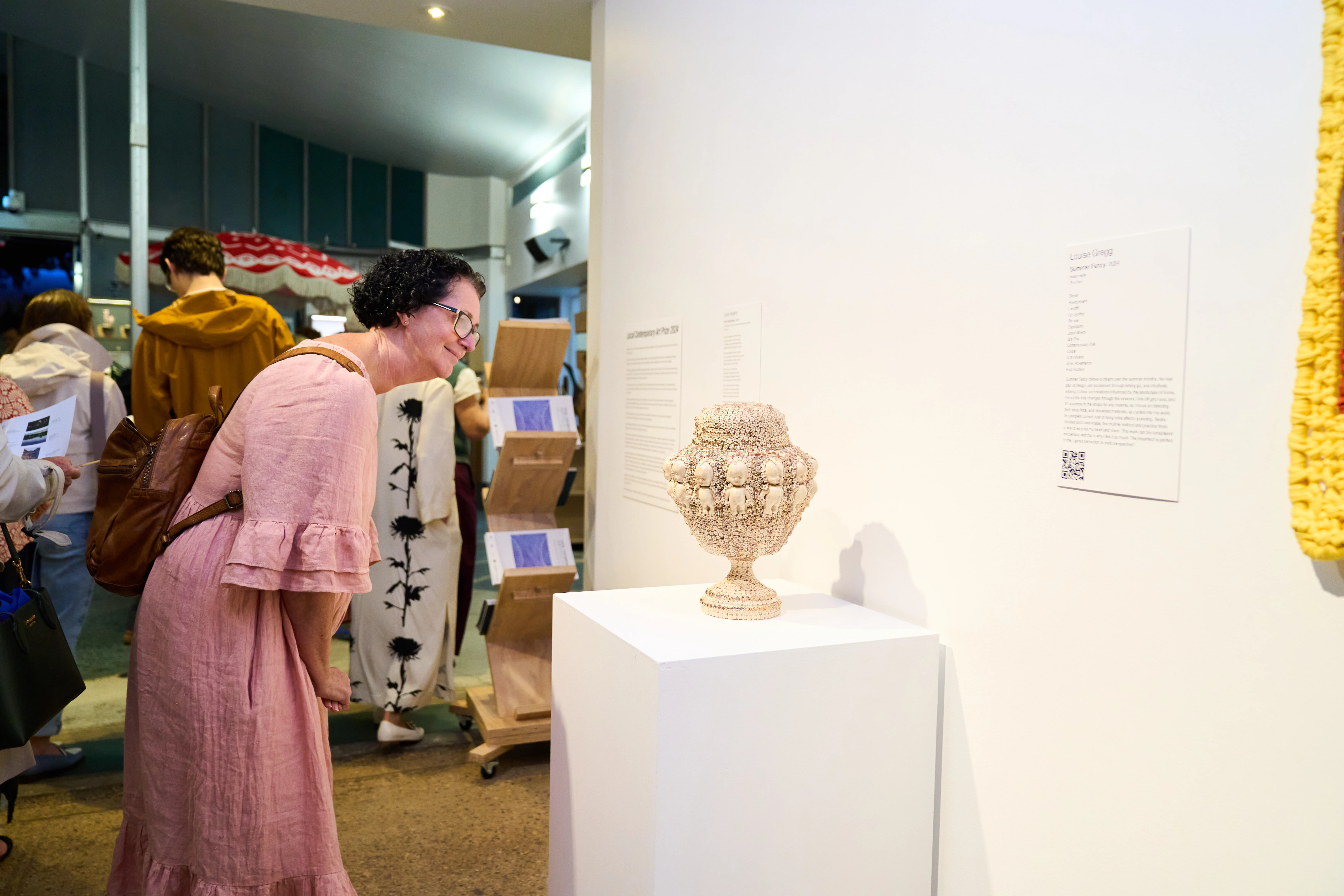 gallery visitor studying one of the finalist entries, 2024 Local Contemporary Art Prize exhibition