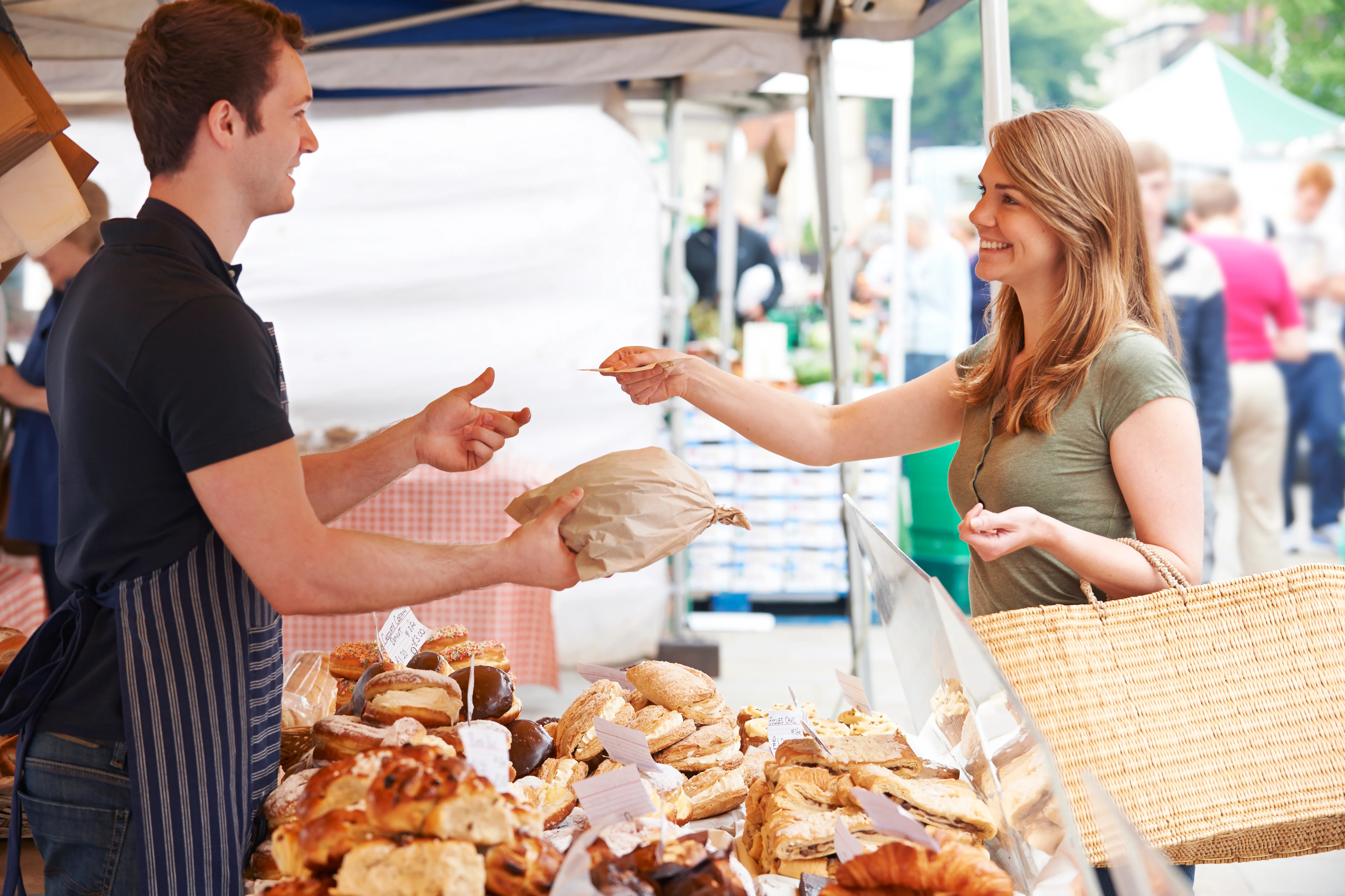 lady paying for bread at a market