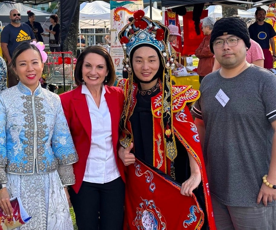 Mayor Rosanna Natoli and three people wearing traditional Chinese costumes, are smiling at the camera.