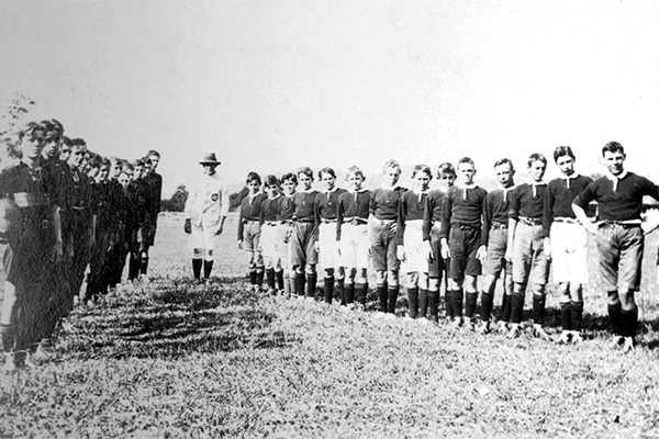 Nambour Rural School's footballers facing their opposing team, Nambour, ca 1920.