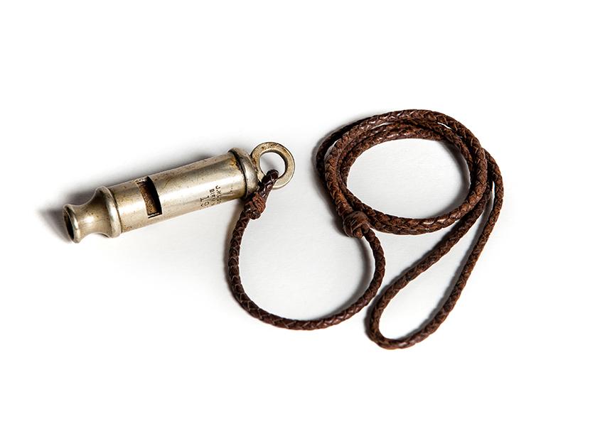 1915 Army whistle with lanyard. Army whistles were a vital communication tool. Their sound told troops it was time to go "over the top" and also warned artillerymen that their gun was about to fire, so that they could avoid being injured by the recoil - Landsborough Historical Museum Collection