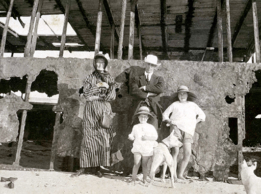 Spink family members standing by the rusting remains of the SS Dicky c.1923. Donald Spink (centre) with his mother-in-law, Catherine Turner (left), his daughter, Nancy (centre foreground) and a young family friend or relative (right). Photograph taken by Donald's wife Bessie Spink. Courtesy Lindsay Powell.