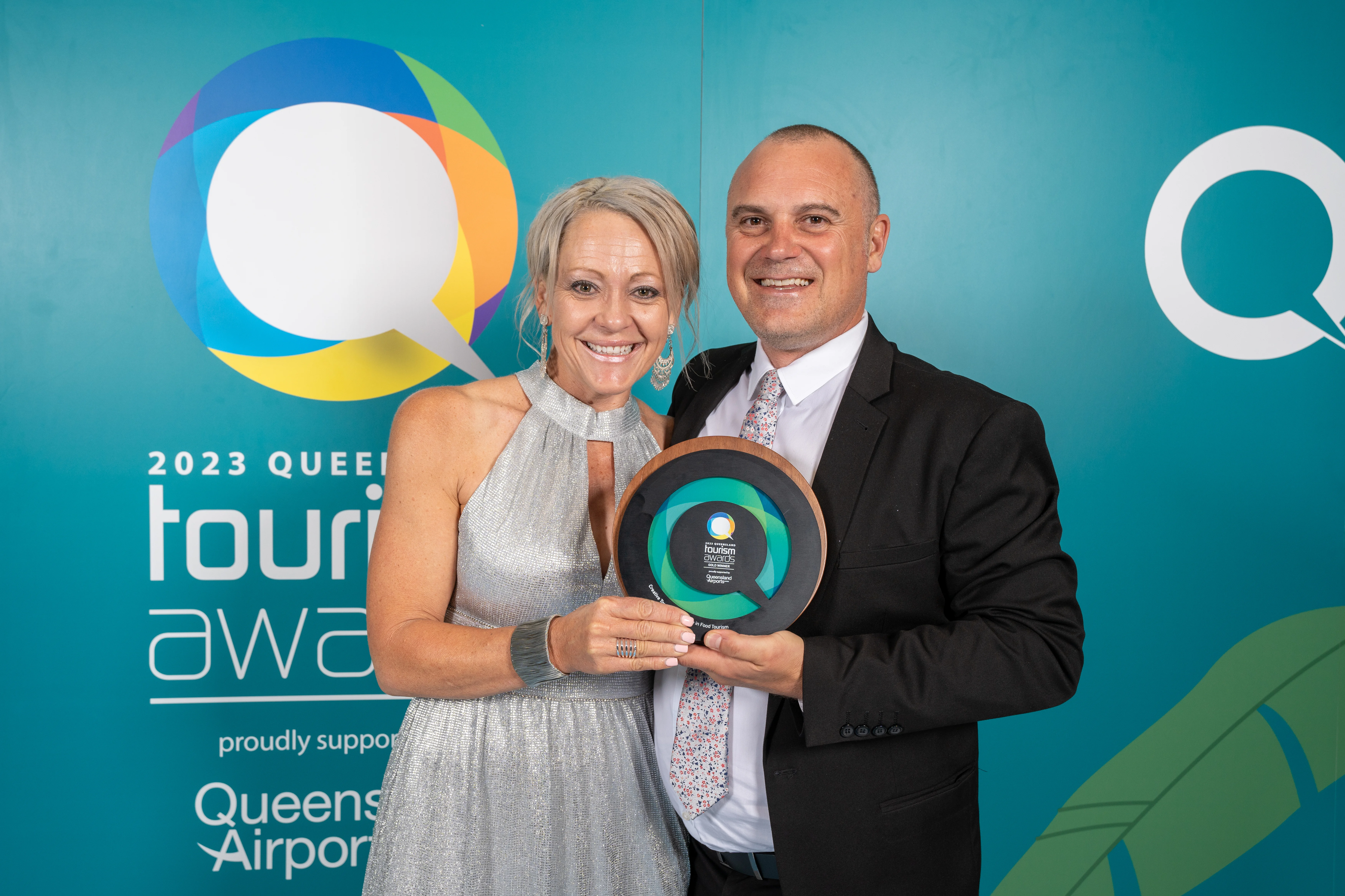 Creative Tours holding their Queensland Tourism award.