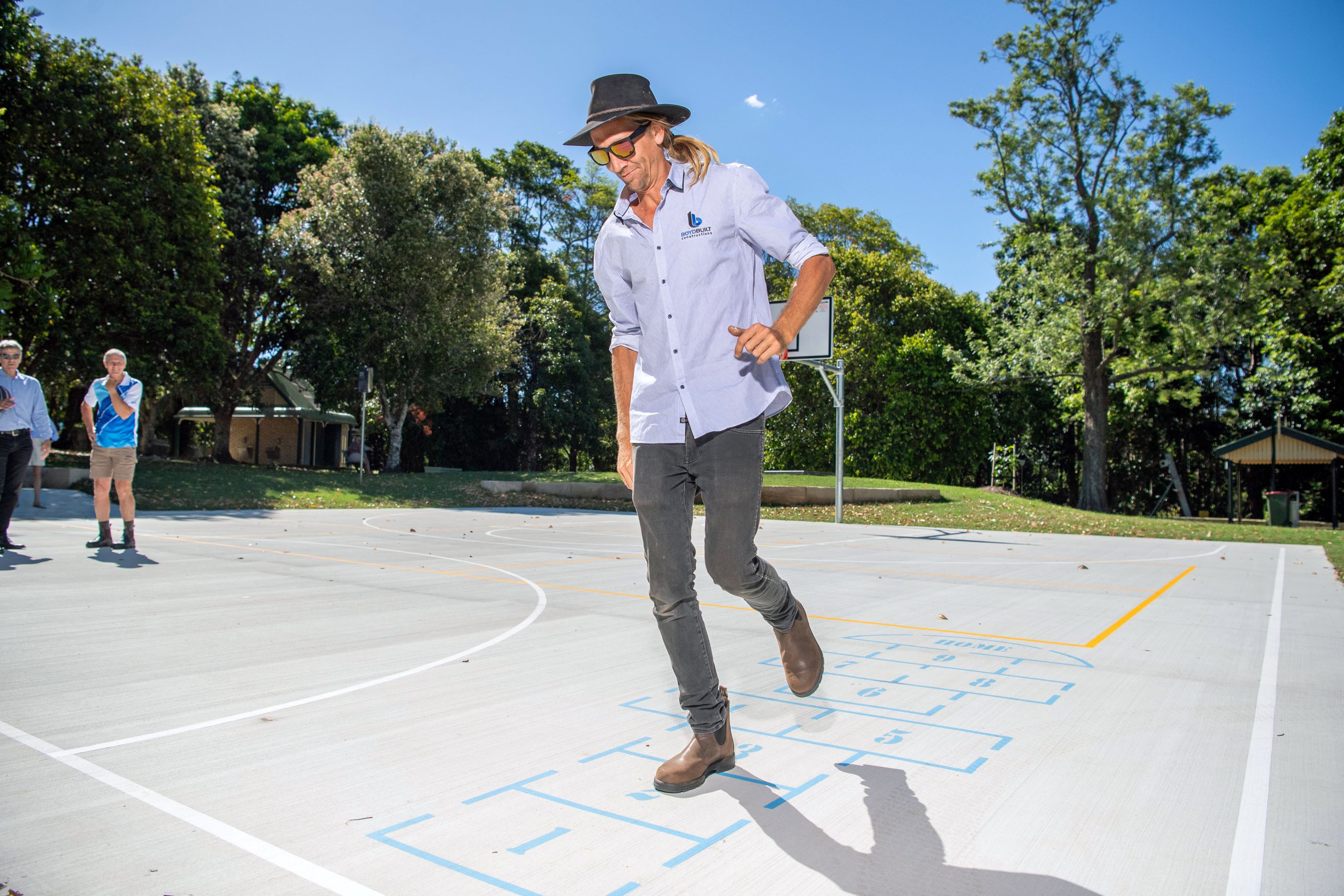 A man testing the hopscotch on the new basketball half court at Mapleton Lilyponds Park