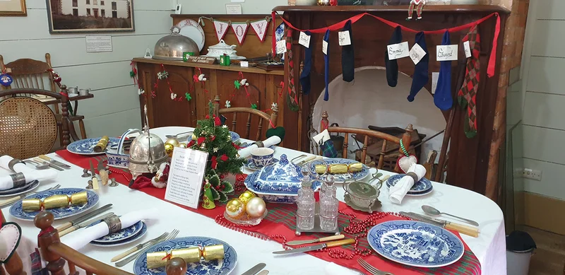 Experience the cosy festive dining room at Buderim Pioneer Cottage, decorated with home-made trinkets. Such a treat.