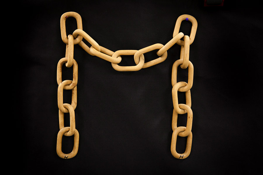 Jim Hall's first incentive to start whittling in earnest came from seeing a large, rough wooden chain hanging in a sideshow tent. This chain was Jim's first effort and was so successful the chain always held pride of place in his whittling displays. The chain is made from a single block of beech timber – Jim Hall Collection, Peachester History Committee Inc.