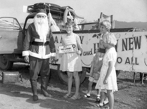 Santa Claus with 'Day & Grimes letter to Santa Competition' winners, Nambour, December 1957.